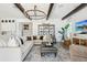 Comfortable living room featuring a large sectional sofa, decorative chandelier, and stylish decor at 15779 Tangerine Dream Ct, Winter Garden, FL 34787