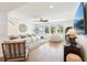 Open-concept living room with large windows offering scenic views, comfortable seating, and a cozy ambiance at 15779 Tangerine Dream Ct, Winter Garden, FL 34787
