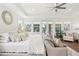 A spacious main bedroom features a bed with lots of pillows and a view of the water at 15779 Tangerine Dream Ct, Winter Garden, FL 34787