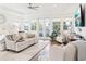 A luxurious main bedroom features seating, water views, and a soothing, neutral color palette at 15779 Tangerine Dream Ct, Winter Garden, FL 34787