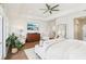 A spacious main bedroom features wood floors, seating, and a view of the water at 15779 Tangerine Dream Ct, Winter Garden, FL 34787