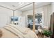 Spacious main bedroom with a four-poster bed, lake view, and access to the outdoor seating area at 15779 Tangerine Dream Ct, Winter Garden, FL 34787