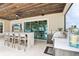 Outdoor kitchen and entertaining space with a built in bar, seating, and grill at 15779 Tangerine Dream Ct, Winter Garden, FL 34787