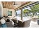 A relaxing outdoor living area showcases comfortable seating and views of the pool and waterfront at 15779 Tangerine Dream Ct, Winter Garden, FL 34787