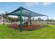 Community playground featuring covered play equipment with a slide and climbing structure for outdoor fun at 15779 Tangerine Dream Ct, Winter Garden, FL 34787