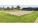 Outdoor sand volleyball court available in this community, surrounded by grass and greenery at 15779 Tangerine Dream Ct, Winter Garden, FL 34787