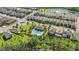 Aerial view of a new housing community with a pool, pond, and well-manicured lawns at 16013 Tollington Aly, Winter Garden, FL 34787