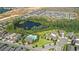 Aerial view of a new housing community with a pond, pool, and well-manicured lawns at 16013 Tollington Aly, Winter Garden, FL 34787