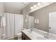 Well-lit bathroom features double sinks, a shower, and modern fixtures at 16013 Tollington Aly, Winter Garden, FL 34787