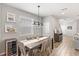 Inviting dining room with wood table, seating for six, and a modern light fixture at 16013 Tollington Aly, Winter Garden, FL 34787