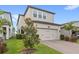 Charming two-story home with a brick driveway, green lawn and well-maintained landscaping at 16013 Tollington Aly, Winter Garden, FL 34787