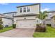 Charming two-story home with a brick driveway, green lawn and well-maintained landscaping at 16013 Tollington Aly, Winter Garden, FL 34787