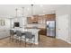 Modern kitchen featuring an island with seating, stainless steel appliances, and wood-look flooring at 16013 Tollington Aly, Winter Garden, FL 34787