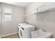 Convenient laundry room includes washer, dryer, utility sink, and shelving at 16013 Tollington Aly, Winter Garden, FL 34787