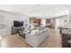 An open living area with an entertainment center, kitchen, dining room, and staircase, offering modern living at 16013 Tollington Aly, Winter Garden, FL 34787