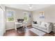 Bright living space features modern desk setup, seating area and wood flooring at 16013 Tollington Aly, Winter Garden, FL 34787