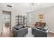 Second floor living room includes modern light fixture, wood floors, stylish chairs, and built-in shelving at 16013 Tollington Aly, Winter Garden, FL 34787