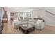 Open-concept living area showcasing a spacious layout with wood-look floors and a cozy seating arrangement at 16013 Tollington Aly, Winter Garden, FL 34787