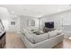 Bright living room with modern decor, wood-look flooring, neutral walls, and comfortable seating area at 16013 Tollington Aly, Winter Garden, FL 34787