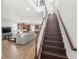 Open-concept living space with wood floors, a staircase, and a view of the kitchen and living area at 16013 Tollington Aly, Winter Garden, FL 34787