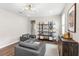 Second floor living room includes modern light fixture, wood floors, stylish chairs, and built-in shelving at 16013 Tollington Aly, Winter Garden, FL 34787