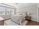 Spacious main bedroom featuring tray ceiling, hardwood floors, soft rug, and lots of natural light at 16013 Tollington Aly, Winter Garden, FL 34787