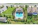 Aerial view of a community pool with lounge chairs and umbrellas surrounded by lush landscaping at 16013 Tollington Aly, Winter Garden, FL 34787