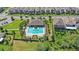 Aerial view of a community pool with lounge chairs and umbrellas surrounded by lush landscaping at 16013 Tollington Aly, Winter Garden, FL 34787