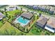Aerial view of a community pool with lounge chairs and umbrellas surrounded by lush landscaping at 16013 Tollington Aly, Winter Garden, FL 34787