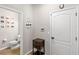 Cozy powder room with wood-look flooring, a decorative welcome sign, and a small storage cabinet at 16013 Tollington Aly, Winter Garden, FL 34787