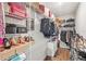 Walk-in closet with wire shelving fully stocked with shoes, bags and clothing at 16013 Tollington Aly, Winter Garden, FL 34787