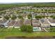 Wide aerial shot displays a community with pools, lakes, and mature landscaping at 1613 Water Elm Ct, Orlando, FL 32825
