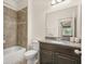 Bathroom with granite vanity, tan tile, and a shower/tub combination with decorative tile at 1613 Water Elm Ct, Orlando, FL 32825