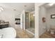 Bright bathroom featuring a glass-enclosed shower, bathtub, sink vanity, and a doorway to a bedroom at 1613 Water Elm Ct, Orlando, FL 32825