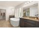 Bathroom with a modern freestanding tub, dual vanities, and plenty of natural light and open closet at 1613 Water Elm Ct, Orlando, FL 32825
