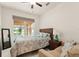 Bedroom featuring a bed, large window, and a sofa, all bathed in natural light for a serene atmosphere at 1613 Water Elm Ct, Orlando, FL 32825