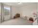 Bright bedroom featuring gray carpet, a large window, and ample space for versatile use at 1613 Water Elm Ct, Orlando, FL 32825