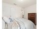 Bedroom with neutral decor, a large bed, and view of the hallway, plus a storage chest at 1613 Water Elm Ct, Orlando, FL 32825