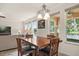 Bright breakfast nook with large windows offering picturesque views of the pool and backyard at 1613 Water Elm Ct, Orlando, FL 32825