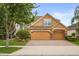 Charming two-story home with a brick driveway, two-car garage, and manicured landscaping at 1613 Water Elm Ct, Orlando, FL 32825