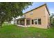 Home exterior view with a screened lanai, manicured lawn, and partial fencing at 1613 Water Elm Ct, Orlando, FL 32825