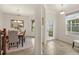 Inviting foyer with tile flooring, a decorative front door and entry to formal dining room at 1613 Water Elm Ct, Orlando, FL 32825