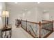 Hallway with wooden railing and neutral carpet at 1613 Water Elm Ct, Orlando, FL 32825