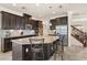 Modern kitchen with granite countertops, stainless steel appliances, and dark wood cabinetry at 1613 Water Elm Ct, Orlando, FL 32825