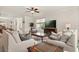 Cozy living room with a ceiling fan, plush sofas, and a large window at 1613 Water Elm Ct, Orlando, FL 32825