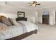 Bright primary bedroom featuring neutral walls, plush carpeting, and dark wooden furniture at 1613 Water Elm Ct, Orlando, FL 32825