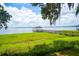 Picturesque view of the lake with a private dock and lush green surroundings at 16400 Lakeshore Dr, Minneola, FL 34715