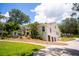 Beautiful home with arched windows, a three-car garage, and a well-maintained lawn at 16400 Lakeshore Dr, Minneola, FL 34715