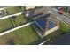 Aerial view of the house with solar panels and a large backyard with white fencing at 171 Seville Dr, Davenport, FL 33837
