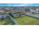 Aerial view of backyard with a well-maintained lawn and a white fence and patio at 171 Seville Dr, Davenport, FL 33837